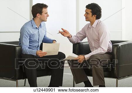 Two businessman talking View Large Photo Image Stock Image - Two businessman talking. Fotosearch