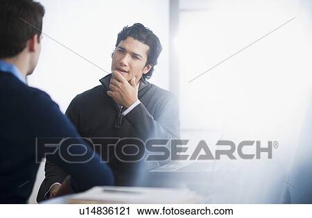 Stock Image - Two businessmen in discussion. Fotosearch