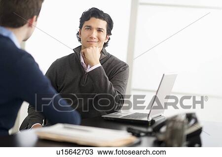 Two businessmen in discussion View Large Photo Image Stock Image - Two businessmen in discussion. Fotosearch