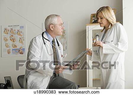 Two doctors discussing on x-ray image View Large Photo Image Stock Image - Two doctors discussing on x-ray image. Fotosearch