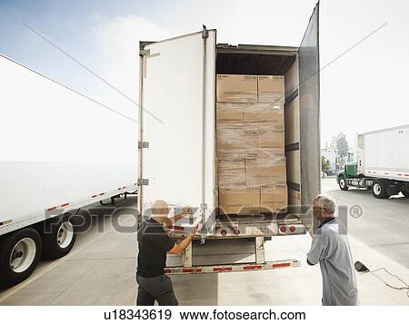 Two men close in truck trailer View Large Photo Image Stock Photo - Two men close in truck trailer. Fotosearch