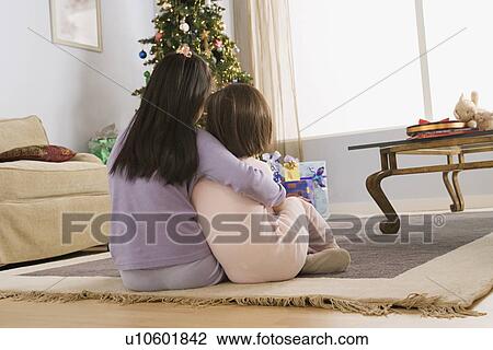 Two sisters (10-11) looking at christmas tree View Large Photo Image Stock Image - Two sisters (10-11) looking at christmas tree. Fotosearch
