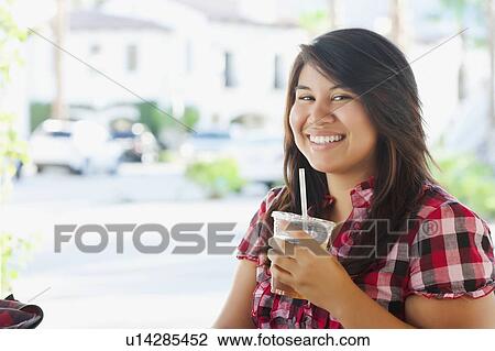 USA, California, La Quinta, Portrait of young woman drinking tea in outdoor cafe View Large Photo Image Stock Image - USA, California, La Quinta, Portrait of young woman drinking tea in outdoor cafe. Fotosearch