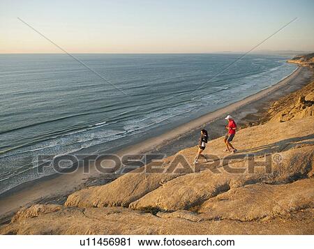 USA, California, San Diego, Man and woman jogging along sea coast View Large Photo Image Stock Image - USA, California, San Diego, Man and woman jogging along sea coast. Fotosearch