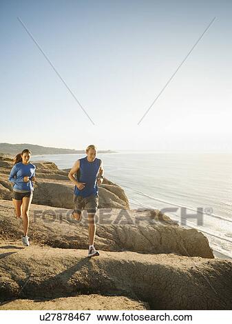 USA, California, San Diego, Man and woman jogging along sea coast View Large Photo Image Stock Photo - USA, California, San Diego, Man and woman jogging along sea coast. Fotosearch