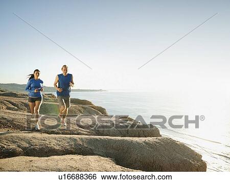 USA, California, San Diego, Man and woman jogging along sea coast View Large Photo Image Stock Photograph - USA, California, San Diego, Man and woman jogging along sea coast. Fotosearch