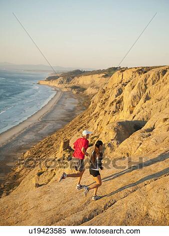 USA, California, San Diego, Man and woman jogging along sea coast View Large Photo Image Stock Photography - USA, California, San Diego, Man and woman jogging along sea coast. Fotosearch