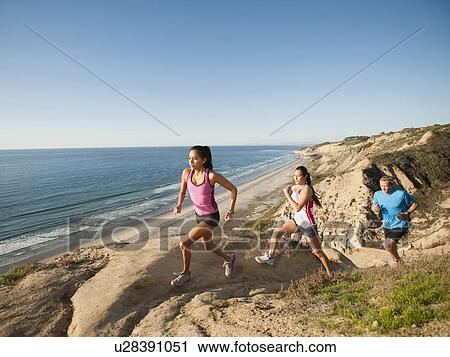 USA, California, San Diego, Three people jogging along sea coast View Large Photo Image Stock Image - USA, California, San Diego, Three people jogging along sea coast. Fotosearch