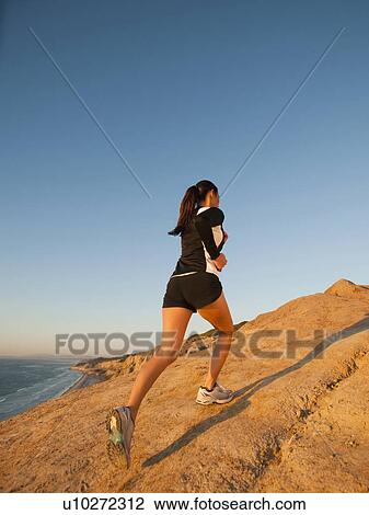 USA, California, San Diego, Woman jogging along sea coast View Large Photo Image Stock Image - USA, California, San Diego, Woman jogging along sea coast. Fotosearch