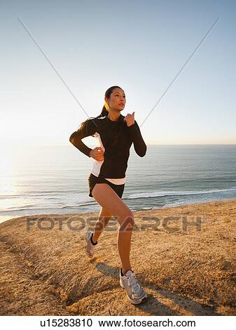USA, California, San Diego, Woman jogging along sea coast View Large Photo Image Stock Image - USA, California, San Diego, Woman jogging along sea coast. Fotosearch