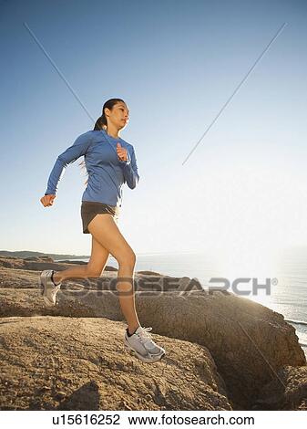 USA, California, San Diego, Woman jogging along sea coast View Large Photo Image Stock Image - USA, California, San Diego, Woman jogging along sea coast. Fotosearch