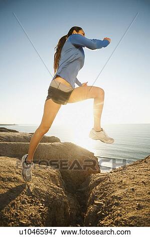 USA, California, San Diego, Woman jogging along sea coast View Large Photo Image Stock Photo - USA, California, San Diego, Woman jogging along sea coast. Fotosearch