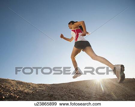 USA, California, San Diego, Woman jogging along sea coast View Large Photo Image Stock Photo - USA, California, San Diego, Woman jogging along sea coast. Fotosearch
