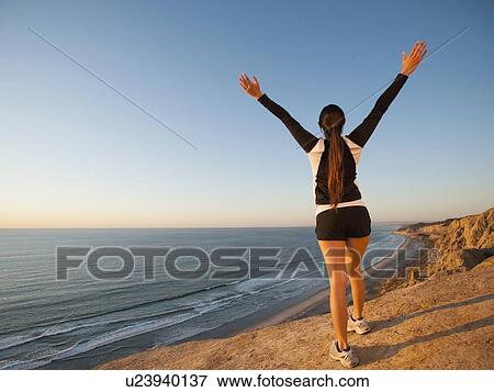 USA, California, San Diego, Woman stretching at beach View Large Photo Image Stock Photo - USA, California, San Diego, Woman stretching at beach. Fotosearch