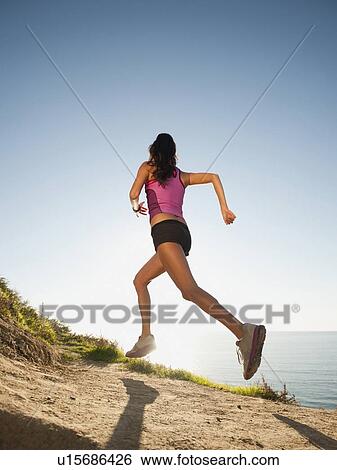 USA, California, San Diego, Woman jogging along sea coast View Large Photo Image Stock Photograph - USA, California, San Diego, Woman jogging along sea coast. Fotosearch