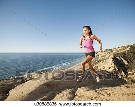 USA, California, San Diego, Woman jogging along sea coast View Large Photo Image Stock Photograph - USA, California, San Diego, Woman jogging along sea coast. Fotosearch