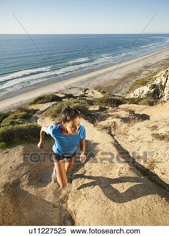 USA, California, San Diego, Woman jogging along sea coast View Large Photo Image Stock Photography - USA, California, San Diego, Woman jogging along sea coast. Fotosearch