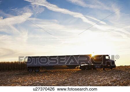 Stock Photograph - USA, Iowa, Latimer, Truck on harvested field . Fotosearch