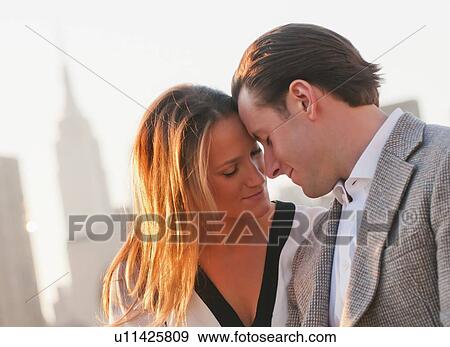 USA, New York, Long Island City, Close-up of happy young couple, Manhattan skyline in background View Large Photo Image Stock Photo - USA, New York, Long Island City, Close-up of happy young couple, Manhattan skyline in background. Fotosearch