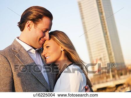 Picture - USA, New York, Long Island City, Young couple embracing outdoors. Fotosearch