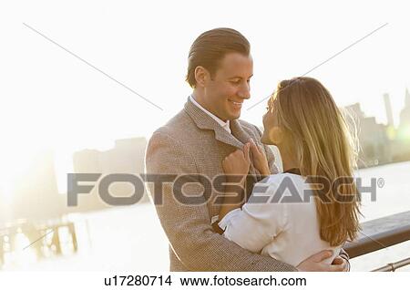 USA, New York, Long Island City, Young couple flirting on bridge, Manhattan skyline in background View Large Photo Image Picture - USA, New York, Long Island City, Young couple flirting on bridge, Manhattan skyline in background. Fotosearch