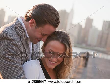 USA, New York, Long Island City, Young couple flirting on bridge, Manhattan skyline in background View Large Photo Image Stock Photo - USA, New York, Long Island City, Young couple flirting on bridge, Manhattan skyline in background. Fotosearch