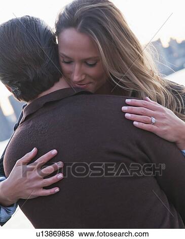 USA, New York, Long Island City, Young couple embracing outdoors View Large Photo Image Stock Photo - USA, New York, Long Island City, Young couple embracing outdoors. Fotosearch