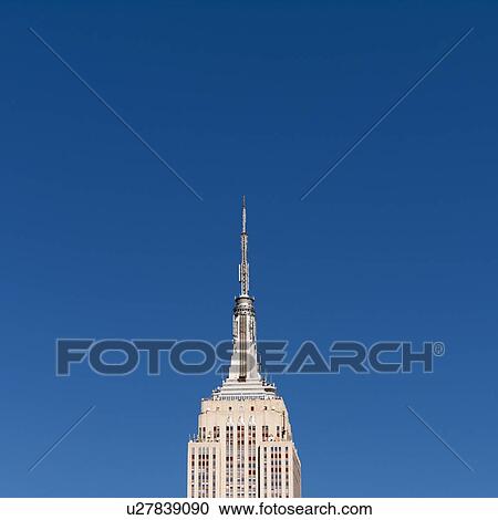 Stock Image - USA, New York, New York City, Empire State Building against blue sky. Fotosearch