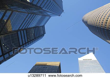 Stock Image - USA, New York, New York City, Manhattan, Upward view of skyscrapers. Fotosearch