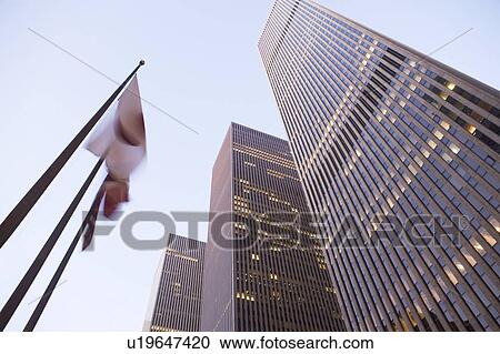Stock Image - USA, New York State, New York City, 6th avenue at night, low angle view. Fotosearch