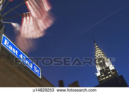 Stock Image - USA, New York State, New York City, low angle view of Chrysler Building and street name sign. Fotosearch