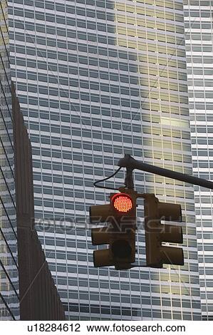 Stock Image - Usa, New York State, New York City, red light in front of skyscraper. Fotosearch