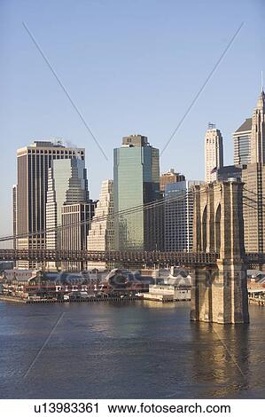 Stock Image - USA, New York State, New York City, Brooklyn Bridge with skyscrapers. Fotosearch