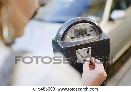 USA, New York State, New York City, Brooklyn, Woman inserting coin into parking meter View Large Photo Image Stock Image - USA, New York State, New York City, Brooklyn, Woman inserting coin into parking meter. Fotosearch