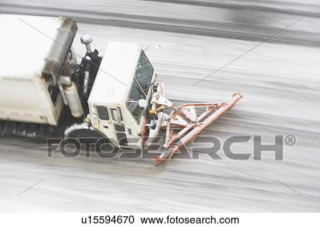 Stock Image - USA, New York State, New York City, high angle view of Snowplow plowing snow out of street. Fotosearch