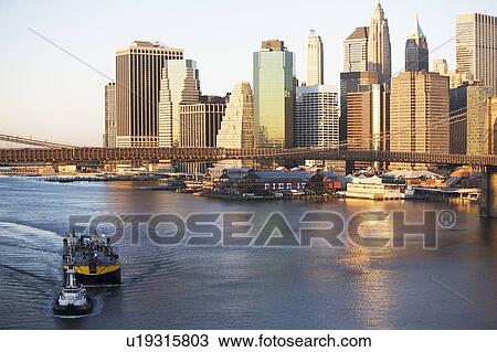 Stock Image - USA, New York state, New York city, Brooklyn Bridge with skyscrapers. Fotosearch