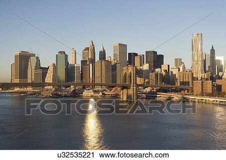 Stock Image - USA, New York state, New York city, Brooklyn Bridge with skyscrapers. Fotosearch