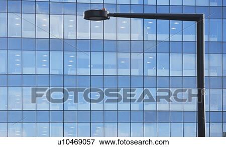 Stock Photo - USA, New York state, New York city, street light in front of skyscraper. Fotosearch