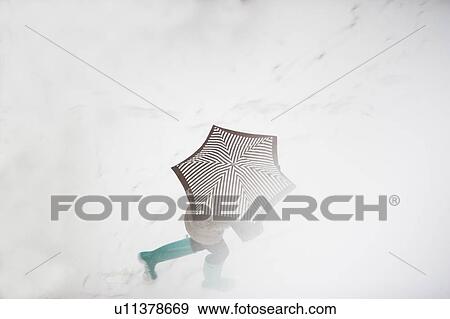 Stock Photo - USA, New York State, New York City, pedestrian walking with umbrella. Fotosearch