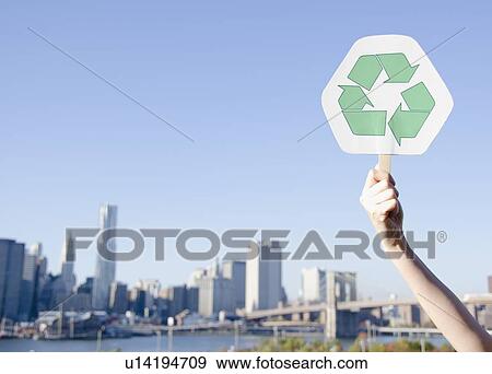 Stock Photo - USA, New York State, New York City, Manhattan, Hand holding recycling symbol. Fotosearch