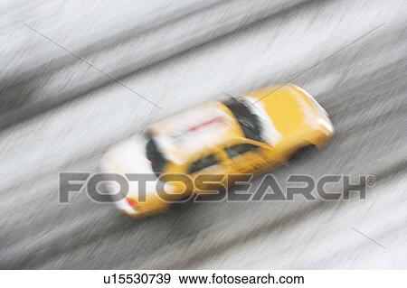 Stock Photo - USA, New York State, New York City, blurred motion of yellow taxi. Fotosearch