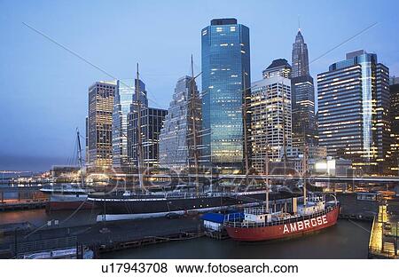 Stock Photo - USA, New York State, New York City, seaport museum with skyscrapers in background. Fotosearch