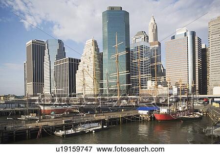 Stock Photo - USA, New York state, New York city, sailboats in front of skyscrapers. Fotosearch