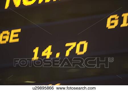 Stock Photograph - Usa, New York State, New York City, Times Square, Stock Quotron, close-up of Ticker Tape Machine. Fotosearch