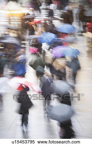 Stock Photography - USA, New York state, New York city, pedestrians walking with umbrellas. Fotosearch