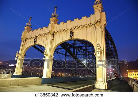 Stock Image - USA, Pennsylvania, Pittsburgh, Old bridge at night. Fotosearch