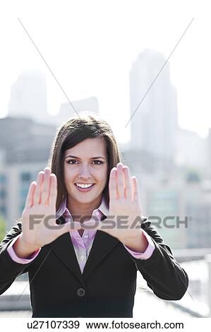 USA, Seattle, Smiling businesswoman making frame with hands View Large Photo Image Stock Photo - USA, Seattle, Smiling businesswoman making frame with hands. Fotosearch