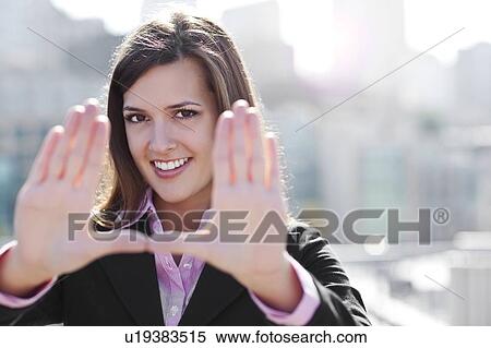 USA, Seattle, Smiling businesswoman making frame with hands View Large Photo Image Stock Photography - USA, Seattle, Smiling businesswoman making frame with hands. Fotosearch