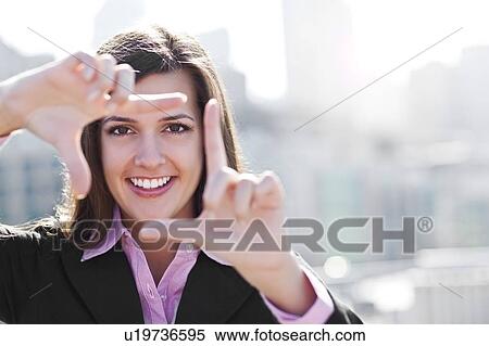 USA, Seattle, Smiling businesswoman making frame with hands View Large Photo Image Stock Photography - USA, Seattle, Smiling businesswoman making frame with hands. Fotosearch