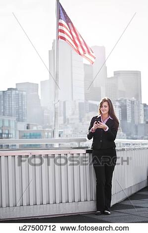 USA, Seattle, Smiling young businesswoman using mobile View Large Photo Image Stock Image - USA, Seattle, Smiling young businesswoman using mobile. Fotosearch
